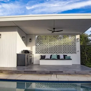 Modern outdoor patio with pool and seating area.