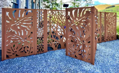 Decorative metal garden fence with intricate designs.