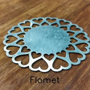 Heart-shaped metal coaster on wooden surface