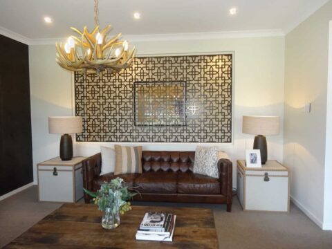 Modern living room with brown leather sofa and decor.