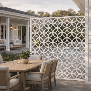 Outdoor patio with decorative white panel and furniture.