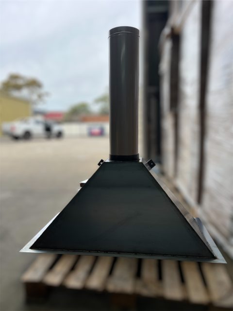 Metal chimney stack on wooden pallet.