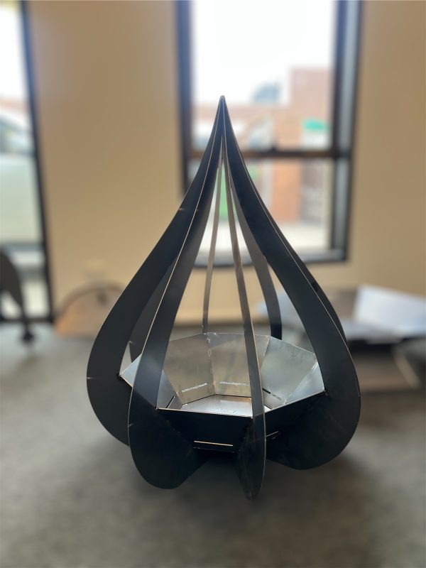 Black metal sculpture in indoor setting